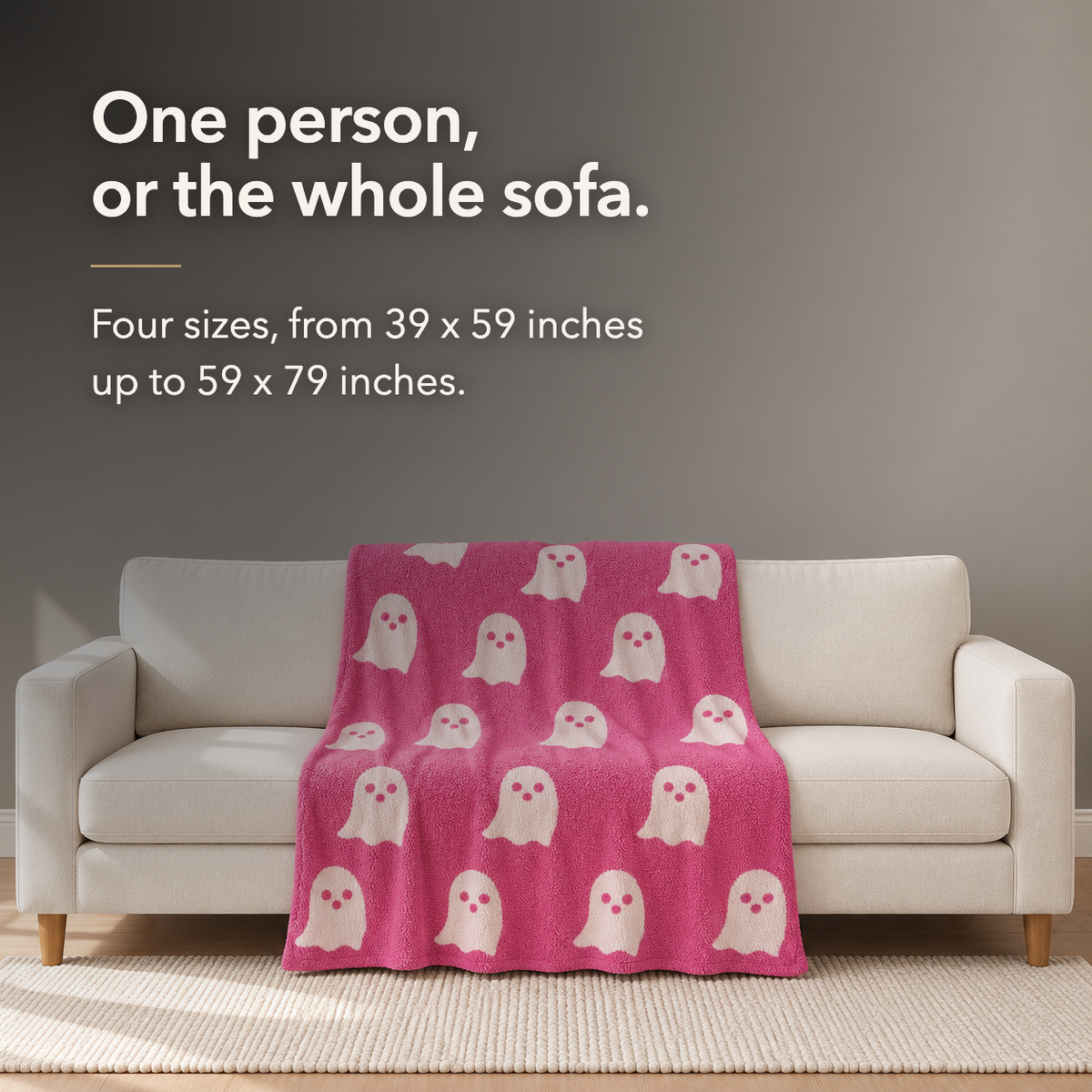Pink ghost knit throw blanket spread across a three seat cream sofa, lettered with the words one person, or the whole sofa, and the four sizes in inches