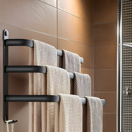 Matte black aluminum wall mounted towel rack with three stepped bars holding waffle towels on brown bathroom tiles beside a glass shower, a pair of small hooks at the foot of its end plate