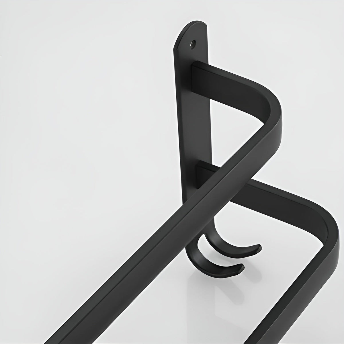 Studio close-up of a matte black aluminum towel rack end plate with two rounded bars stepping out from it and a pair of small J hooks at its foot
