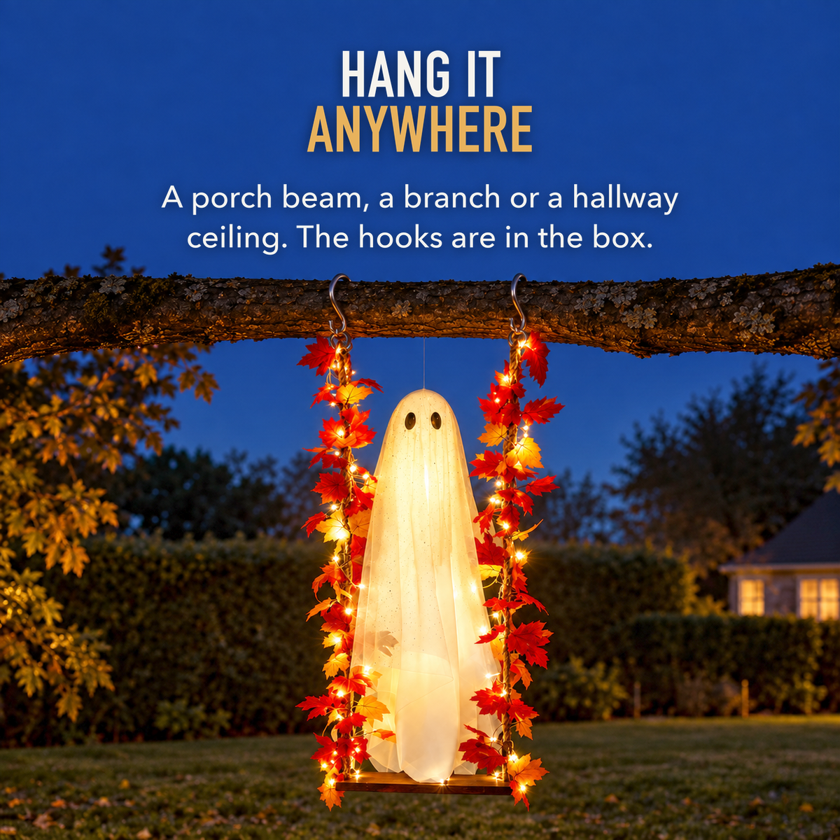 Ghost swing hanging from a tree branch in a garden at dusk, lit, with the words Hang It Anywhere