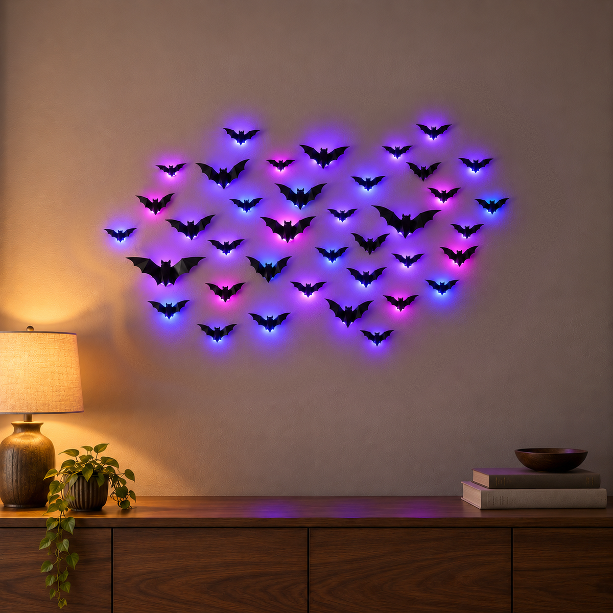 LED bat wall decorations glowing purple on a den wall in the evening, each black bat lit from behind