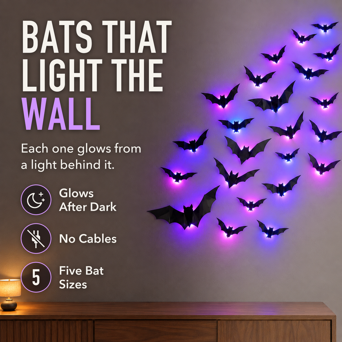 Black LED bat decorations glowing purple on a living room wall in the evening, with the words Bats That Light The Wall, Glows After Dark, No Cables and Five Bat Sizes