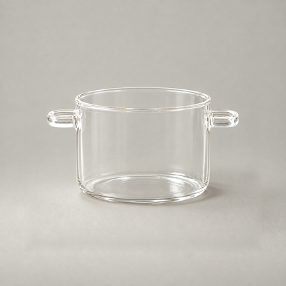 Glass cooking pot without its lid, showing the rounded rim bead, straight clear wall and two open loop handles
