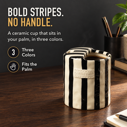 Black striped handleless ceramic cup of coffee on a walnut desk, with the words Bold Stripes. No Handle., Three Colors and Fits the Palm