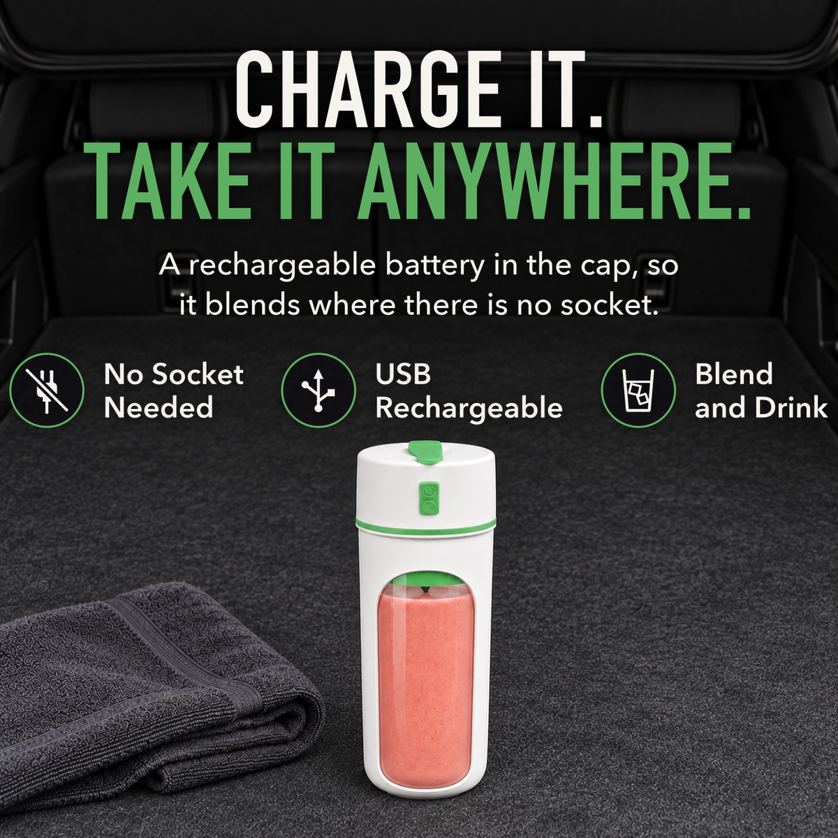 Portable blender cup with green trim full of pink smoothie standing in the open back of a car, with the words Charge It. Take It Anywhere.