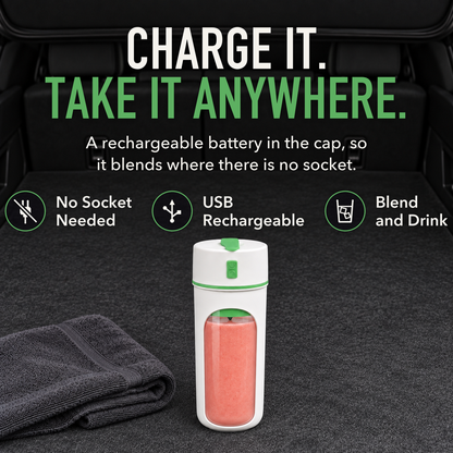 Portable blender cup with green trim full of pink smoothie standing in the open back of a car, with the words Charge It. Take It Anywhere.