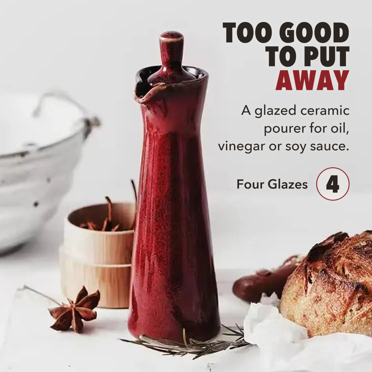 Red ceramic oil dispenser on a white board with bread and star anise, lettered too good to put away