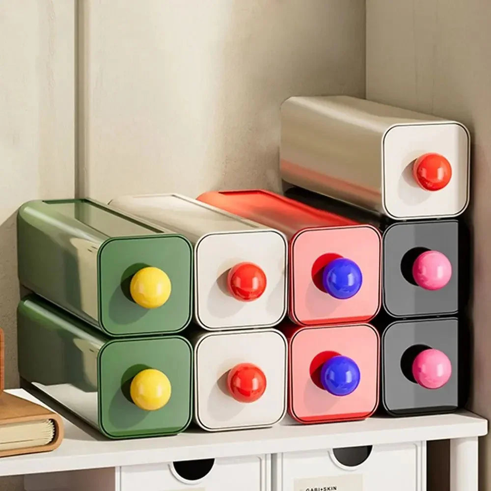 Green, white, red and black storage drawers stacked two high in rows on a white shelf