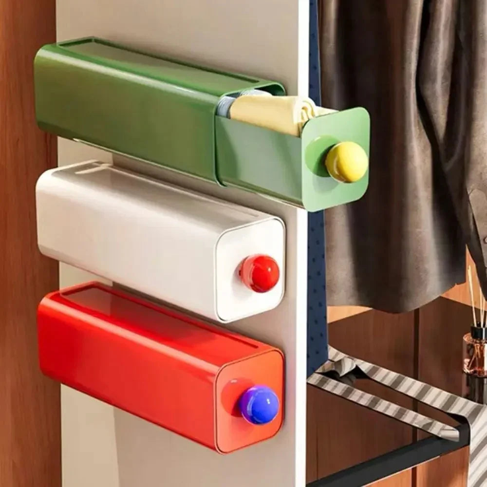 Green, white and red storage drawers mounted on the side of a wardrobe, the green drawer pulled out