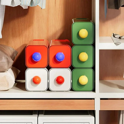 Red, white and green storage drawers stacked in a wardrobe cubby, fronts facing out