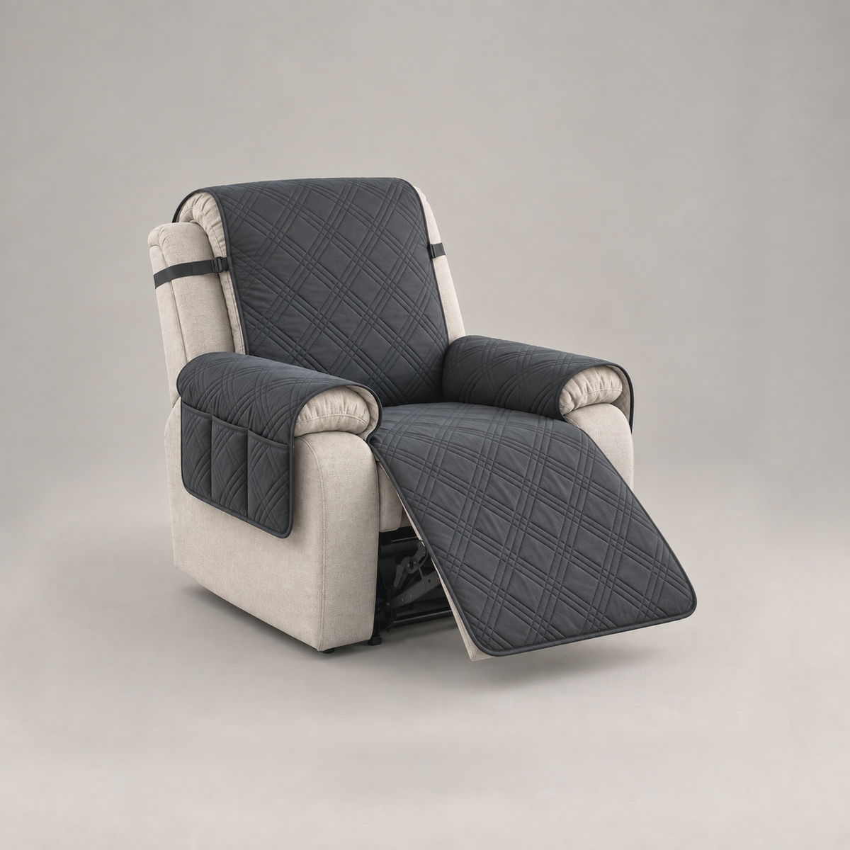 Black quilted recliner slipcover with a three-compartment arm pocket on a stone fabric recliner, footrest out, on a plain grey background