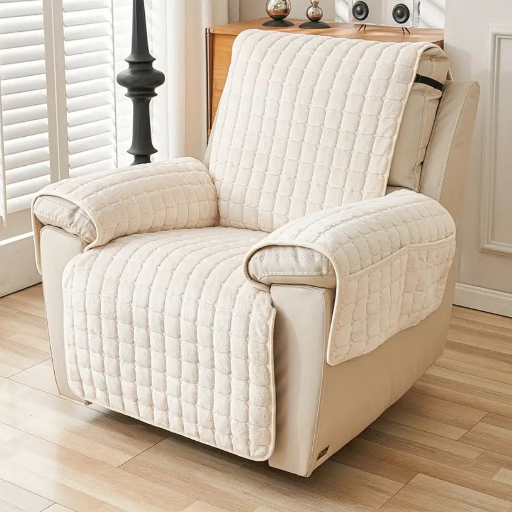 Beige grid quilted recliner cover with two arm covers on a cream leather recliner