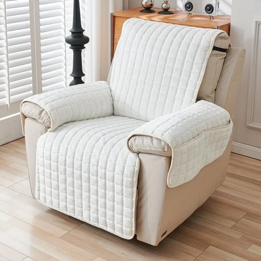 White grid quilted recliner cover with two arm covers on a cream leather recliner