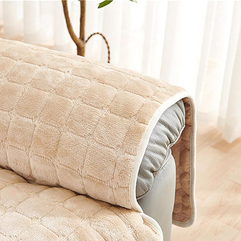 Close-up of a beige quilted arm cover over a recliner arm, showing the bound edge