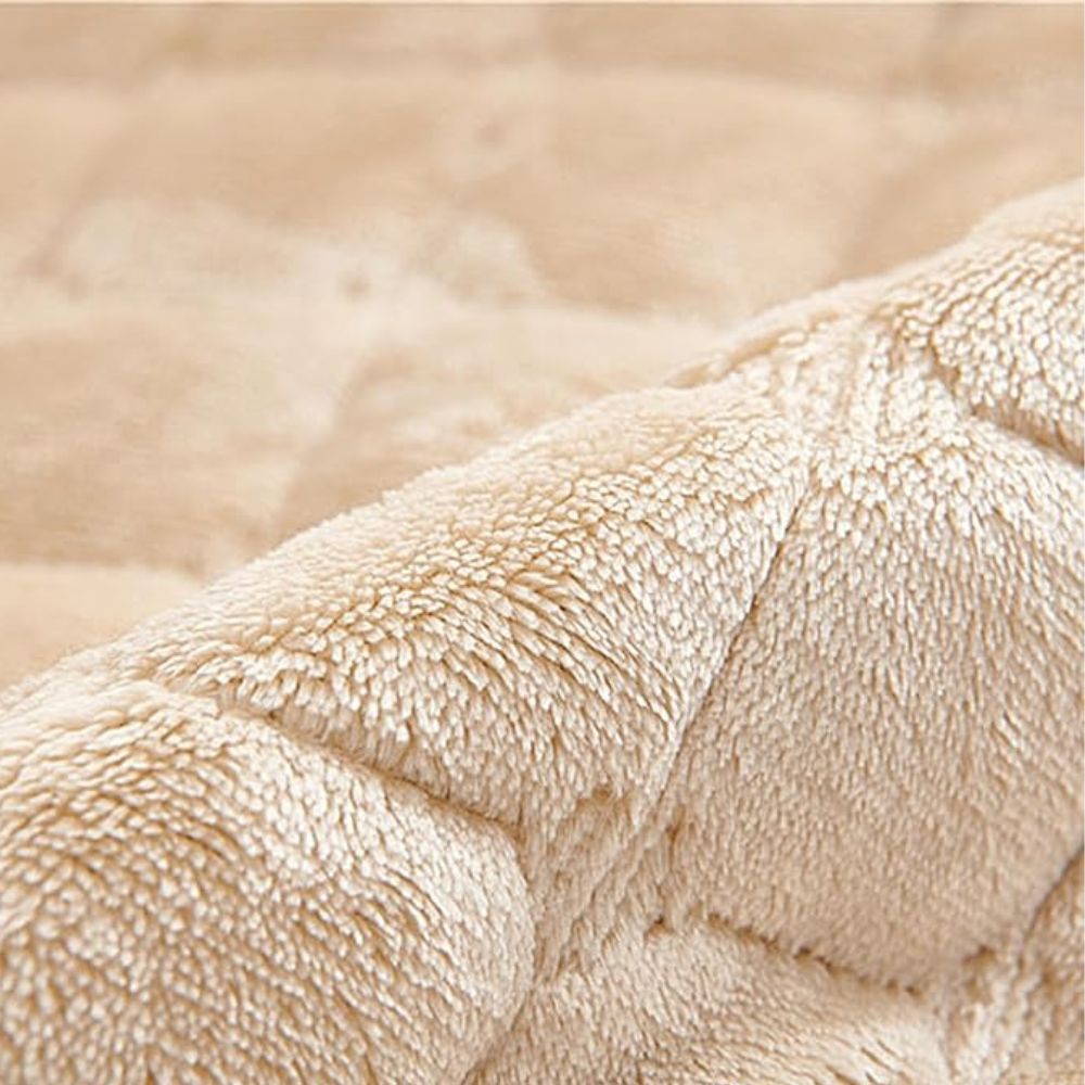 Close-up of the soft beige quilted pile of the recliner cover