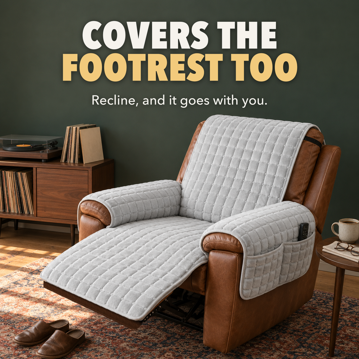 Gray grid quilted cover on a reclined cognac leather recliner in a green den, covering the raised footrest, with the words Covers the footrest too