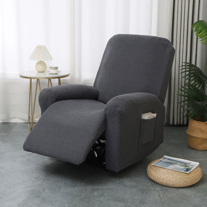 Charcoal stretch recliner cover in four fitted pieces on a single recliner with the footrest raised and a book in the side pocket