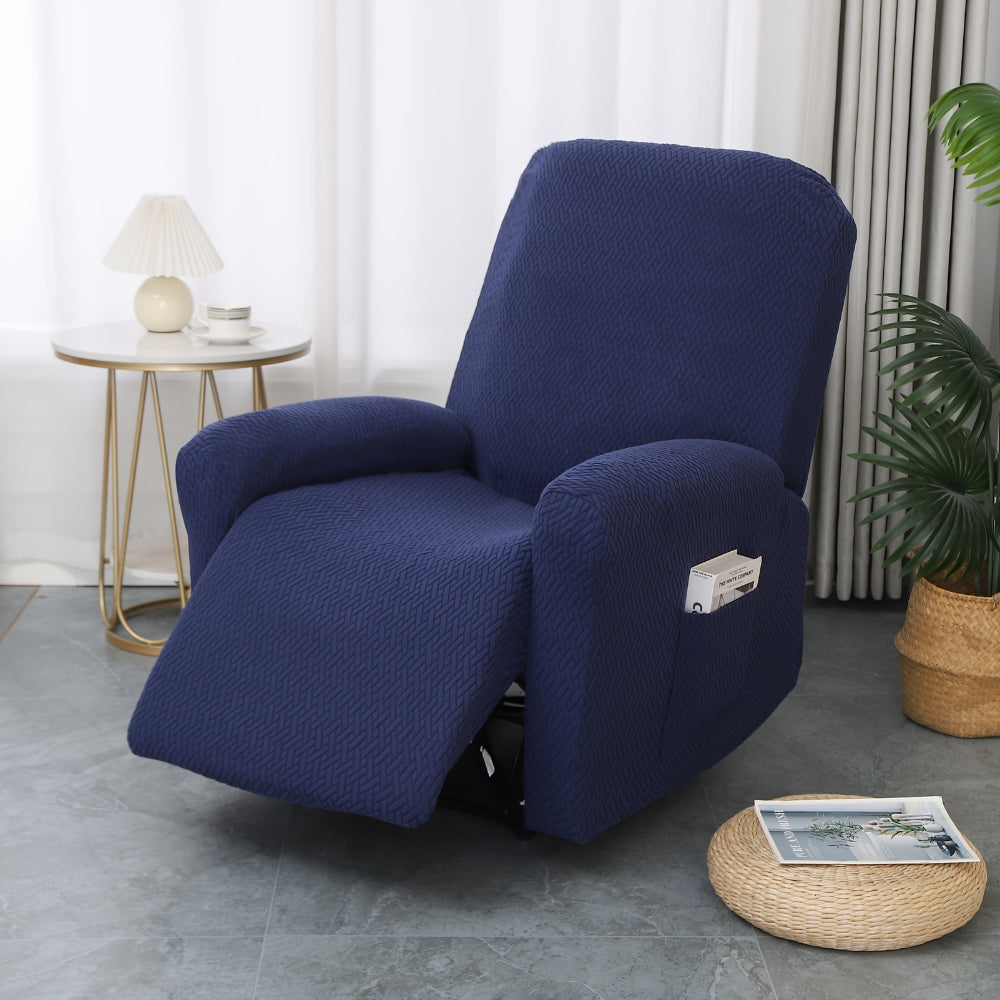 Navy stretch jacquard recliner cover fitted over a recliner with the footrest up, beside a gold side table and lamp