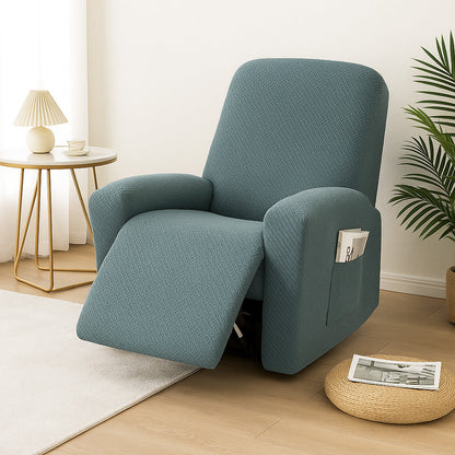 Teal stretch recliner cover on a recliner in a living room with a wood floor and a cream rug