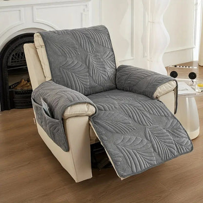 Charcoal leaf quilted recliner cover on a cream recliner with the footrest up, arm covers and side pocket