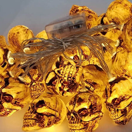 A whole skull string light heaped and lit, with the clear battery box on top