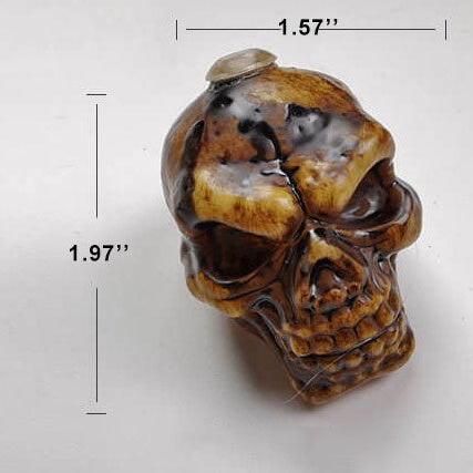 One unlit brown skull from the string lights, measured at about 1.5 inches wide and 2 inches tall