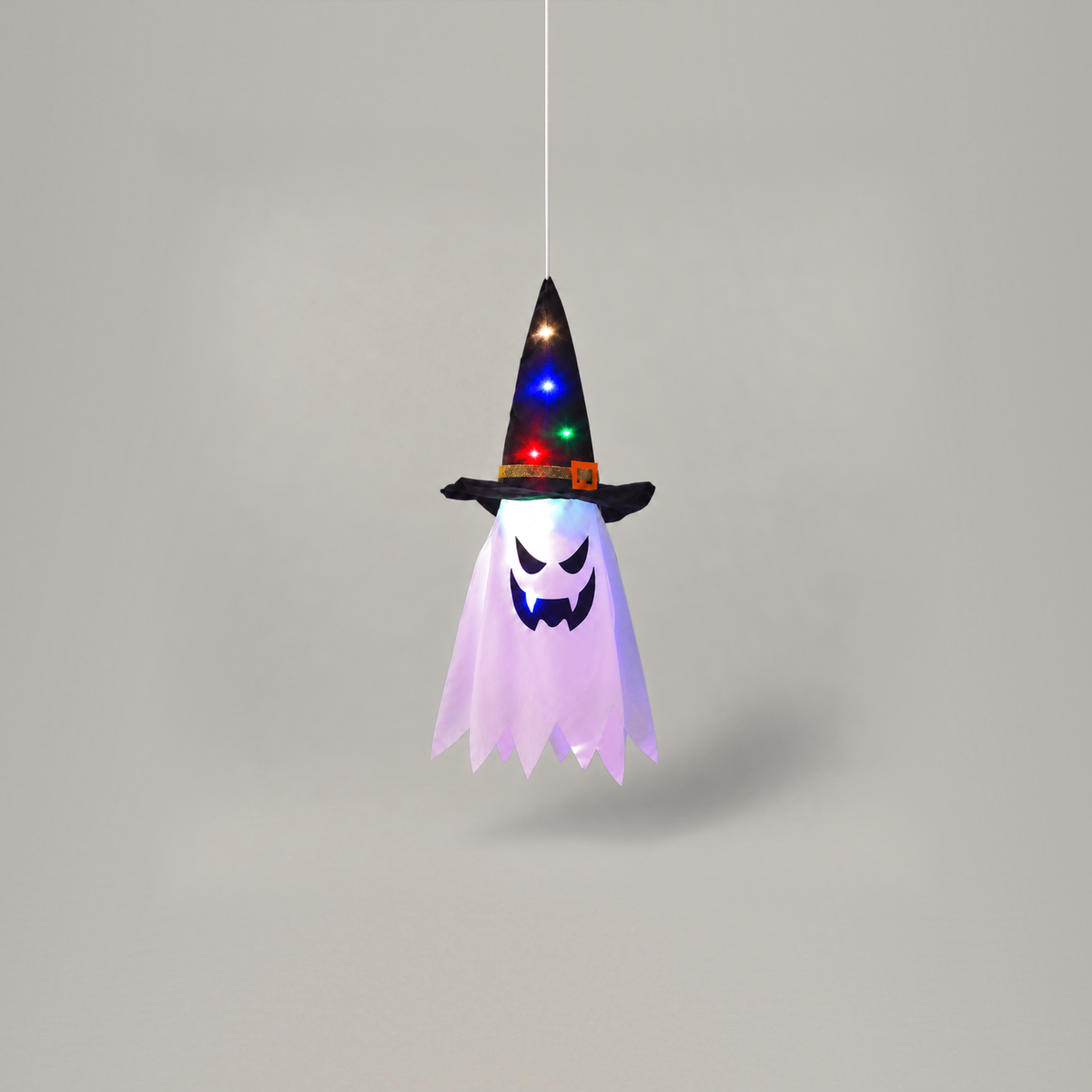 Single witch hat ghost light hanging straight down from a cord on a plain grey background