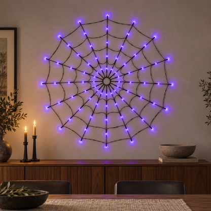 Spider web light glowing purple on a dining room wall above a walnut sideboard in the evening