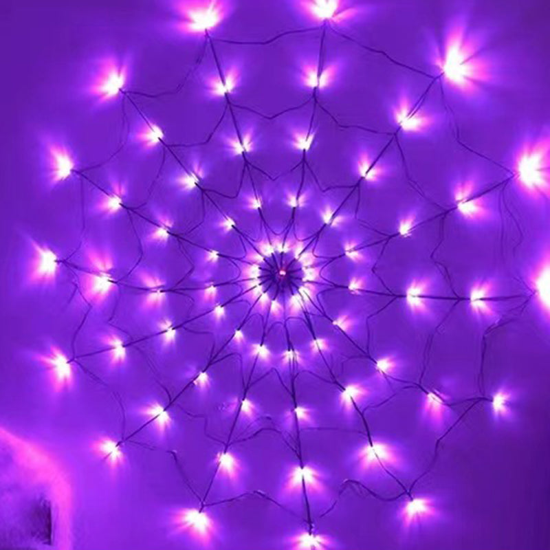 Purple lit spider web light on a purple wall