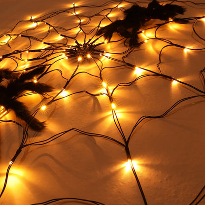 Amber lit spider web light with two plush spiders
