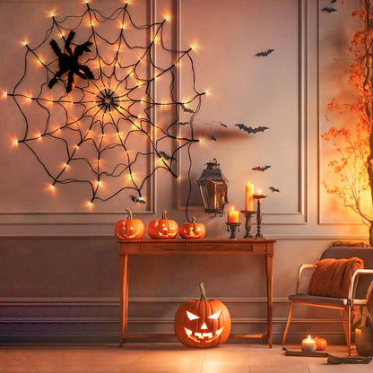 Spider web light on a panelled wall above a console with pumpkins and candles