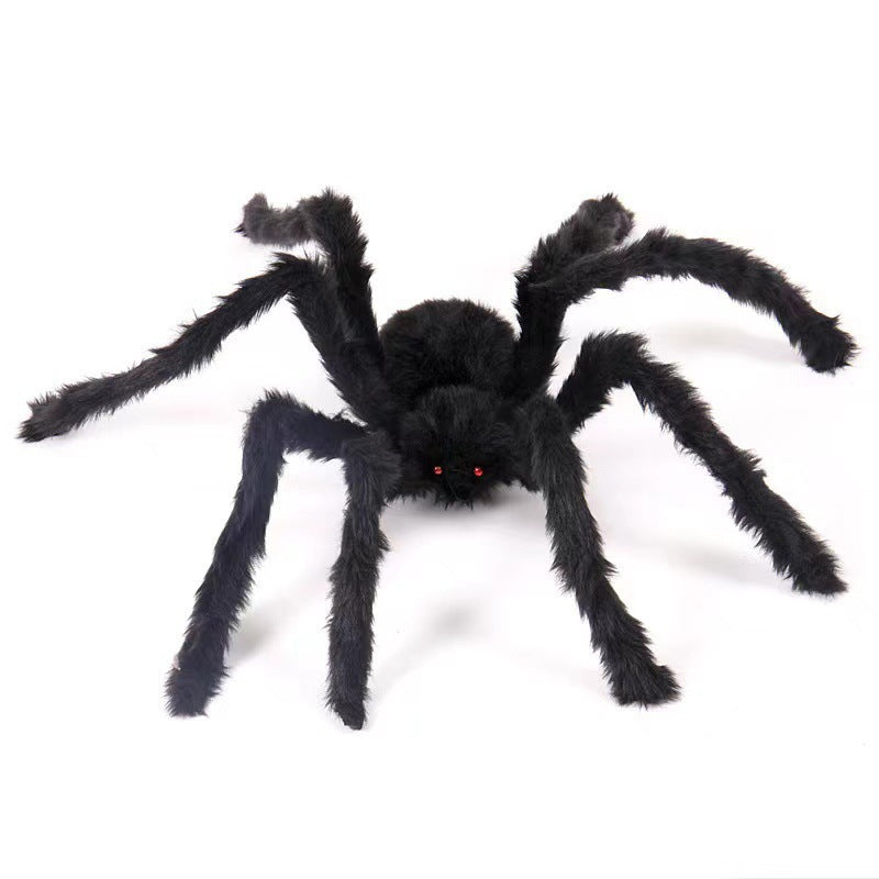 Black plush toy spider on a white background, shown for decoration only