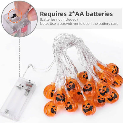 Unlit orange jack-o'-lantern string lights on a clear wire with a clear battery box that takes two AA batteries, batteries not included