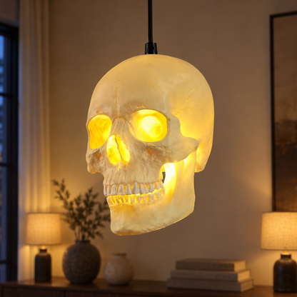 White resin skull pendant light glowing warm over a dining room in the early evening