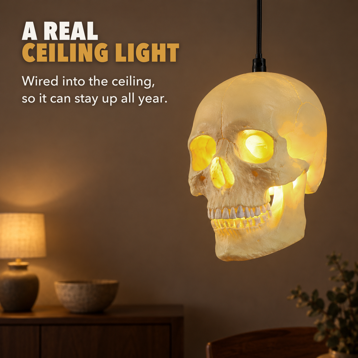 Skull pendant light glowing in a dining room, with the words A real ceiling light