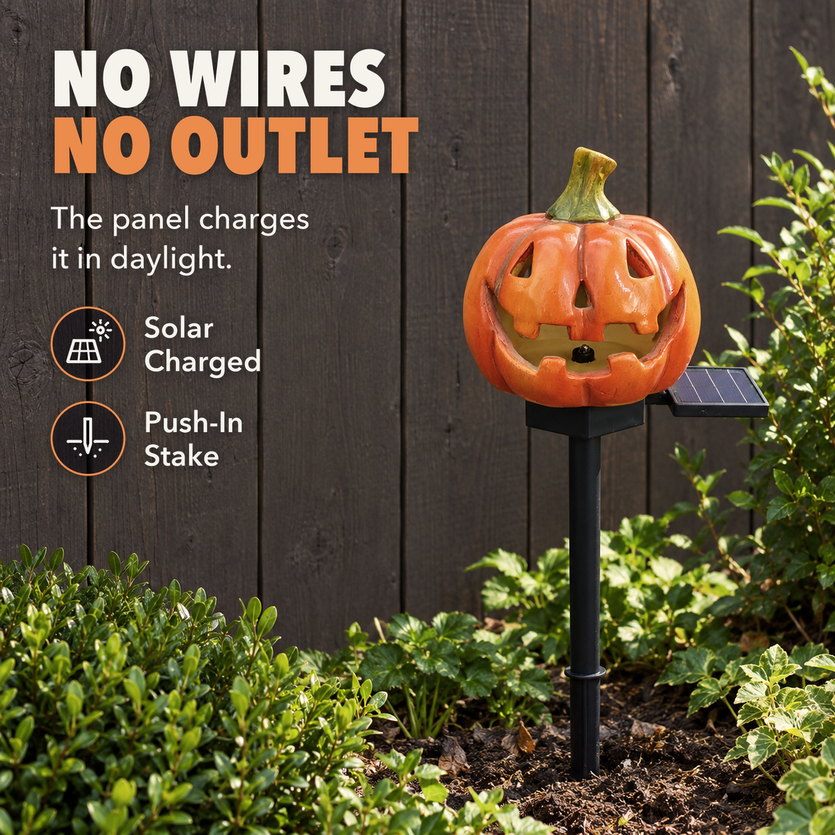 Classic pumpkin stake light in a sunny garden bed with its solar panel beside the head, with the words No wires, no outlet