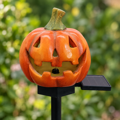 Close-up of the Classic pumpkin stake light showing the carved face, the black cap and the small solar panel
