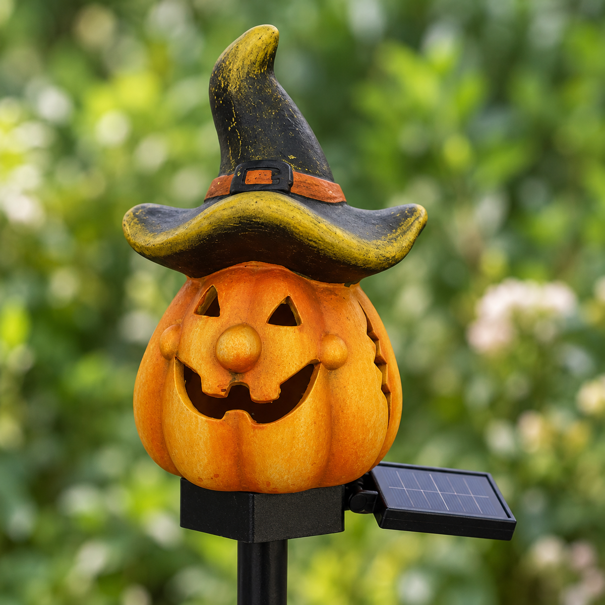 Close-up of the Witch Hat pumpkin stake light showing the hat with its rust band, the face and the solar panel