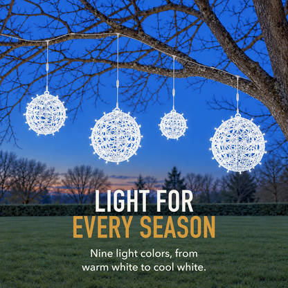 Text image: Light for every season. Four cool white LED ball lights hanging in a bare winter tree at dusk above a garden lawn