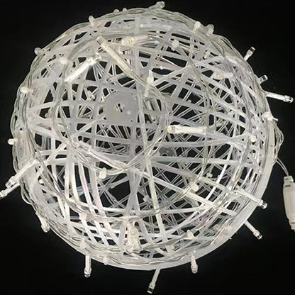 An unlit LED ball light on a black background, showing its milky white woven strips and small clear LEDs