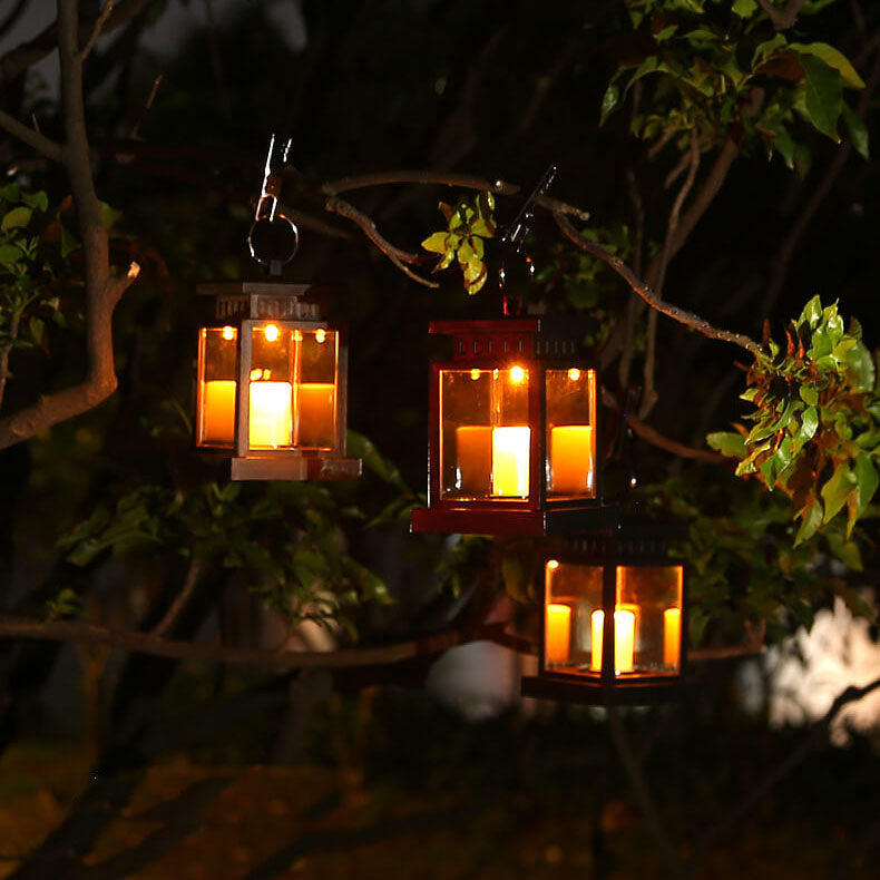 Solar candle lanterns glowing in a tree at night
