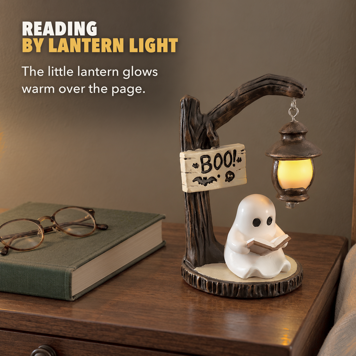 Reading ghost lantern light glowing on a nightstand beside a hardback and reading glasses, with the words Reading by lantern light