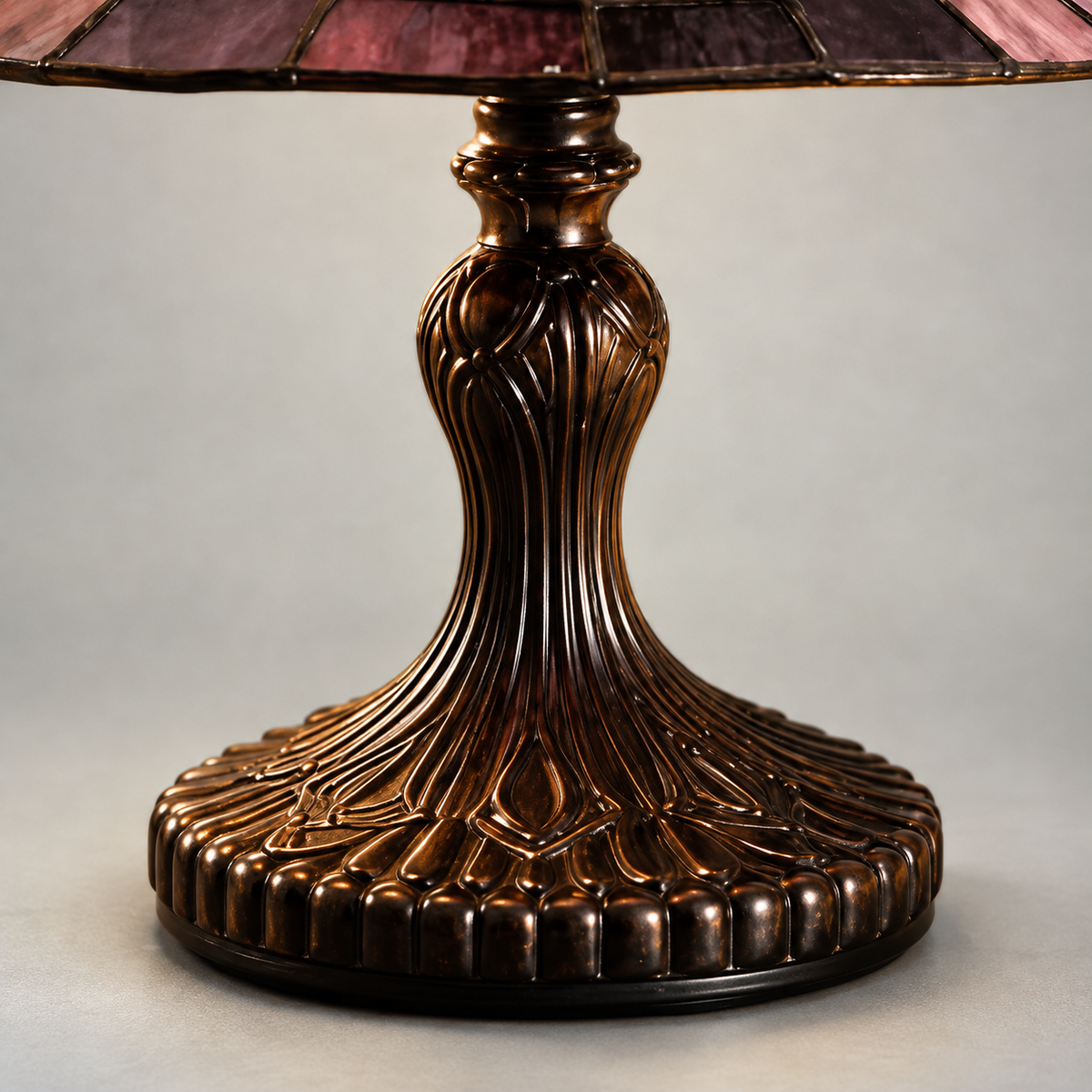Close-up of the lamp's turned pedestal with raised ribs and a scalloped foot in a dark bronze-tone finish