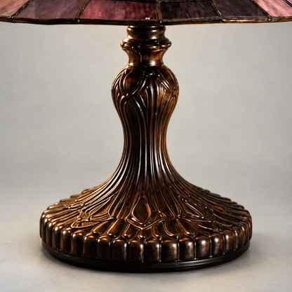 Close-up of the lamp's turned pedestal with raised ribs and a scalloped foot in a dark bronze-tone finish
