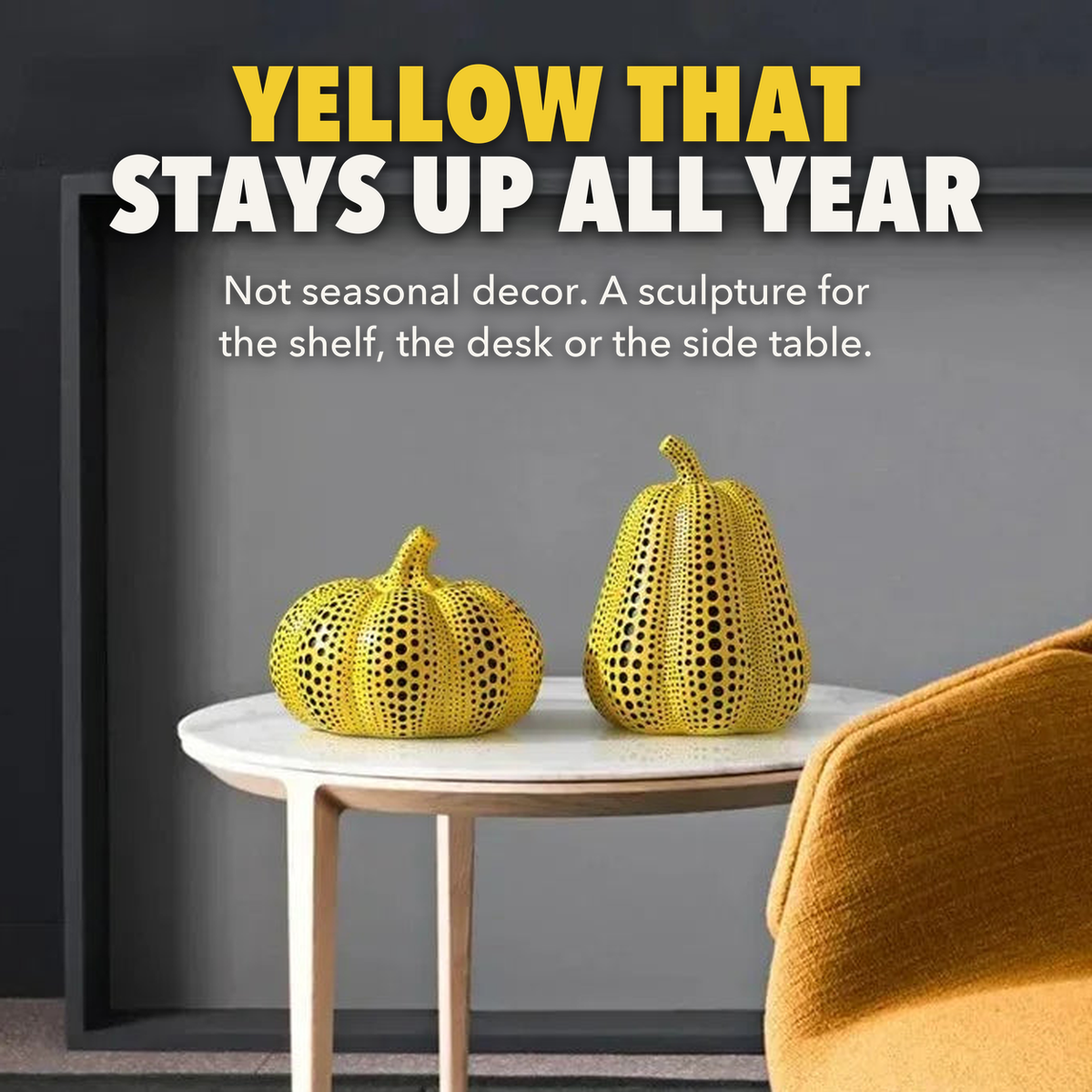 Yellow that stays up all year: polka dot pumpkin and pear sculptures on a white marble side table beside a mustard armchair