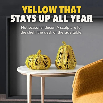Yellow that stays up all year: polka dot pumpkin and pear sculptures on a white marble side table beside a mustard armchair