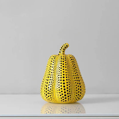 Small Pear polka dot sculpture, a ribbed yellow pear-shaped gourd with a curled stem and black dots, 5.3 inches tall