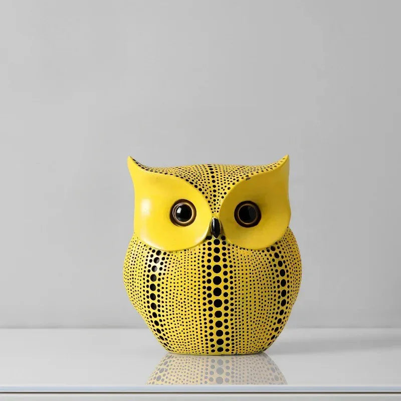 Owl polka dot sculpture with a smooth yellow face, dark round eyes and a black-dotted body, 6.3 inches tall