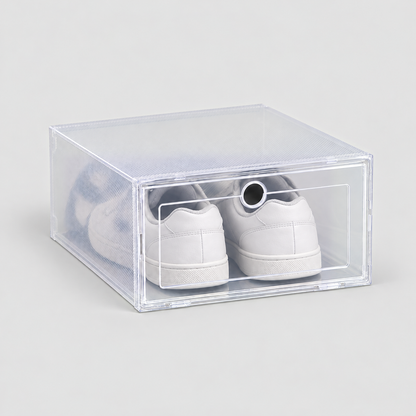 One clear shoe box with a drop front door holding white sneakers, on a plain light grey background