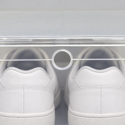 Close-up of the small round finger hole at the top of the shoe box's clear front door